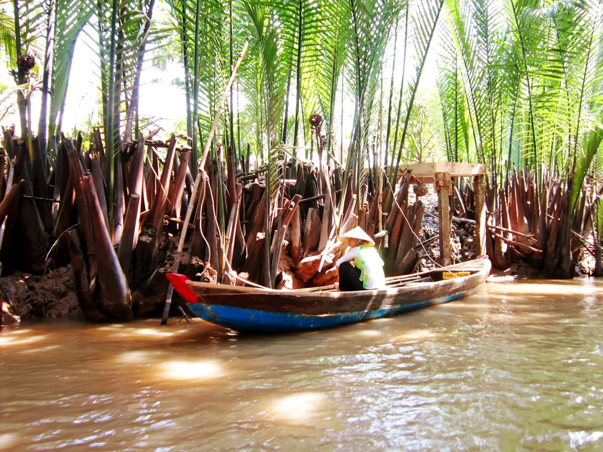 A wooden boat under water coconut palms