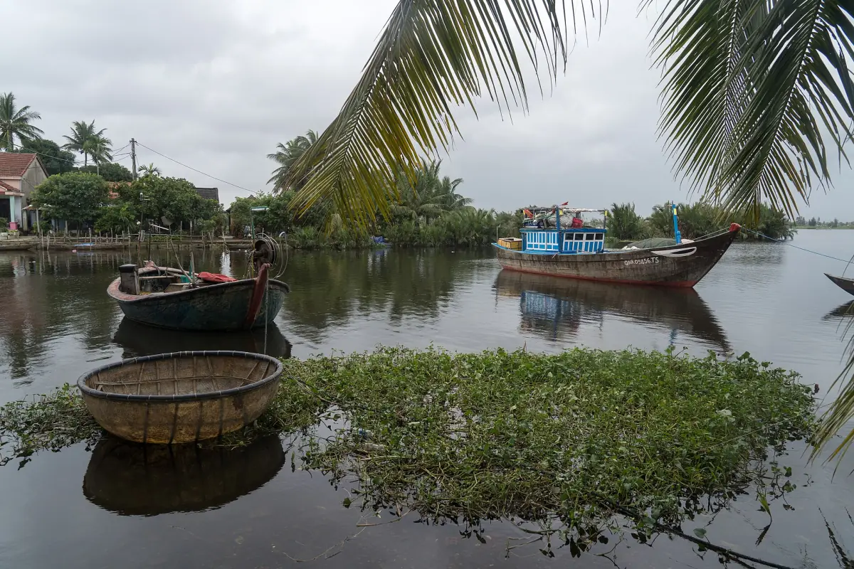 Fishing boats and a basket boat on a river near Hoi An